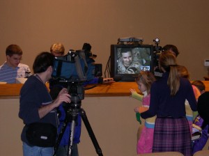 Twin Cities TV News Crews record every word of the first of many Eagan Hills Church services shared with deployed Marines in Fallujah, Iraq. Dec. 4, 2004.